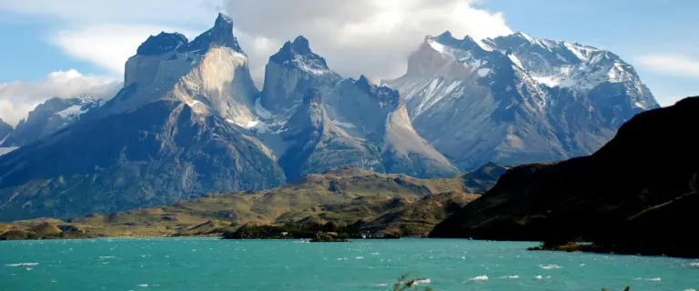 Granite peaks of Torres del Paine above turquoise water in Chilean Patagonia.