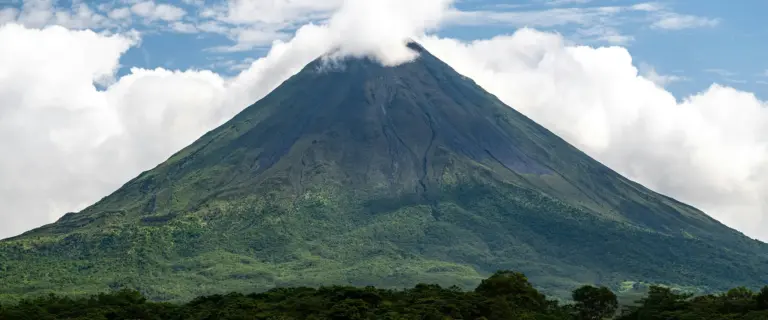 Arenal Volcano rising above green forest in Costa Rica