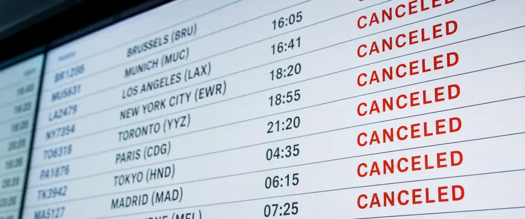 Airport departure board showing multiple canceled international flights